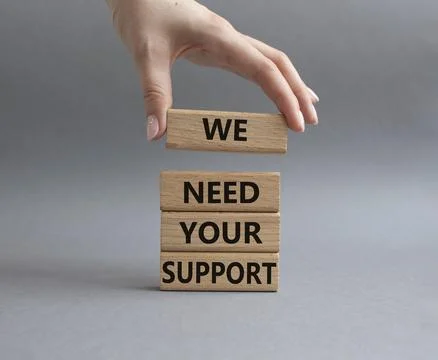 We need your support symbol. Wooden blocks with words We need your support... Stock Photos