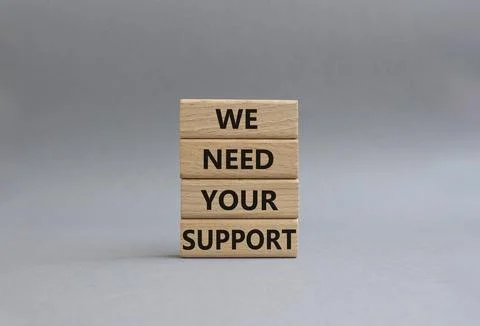 We need your support symbol. Wooden blocks with words We need your support... Stock Photos