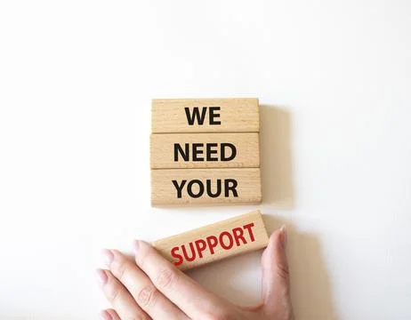 We need your support symbol. Wooden blocks with words We need your support... Stock Photos