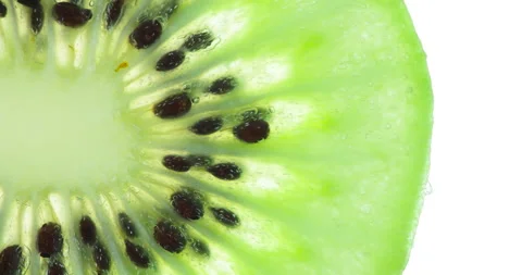 We Press a Bright Slice of Kiwi 4K Video stock 96476103