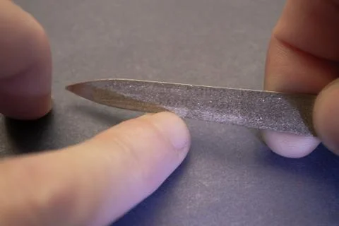 We process the nails on the hands with a nail file. Stock Photos
