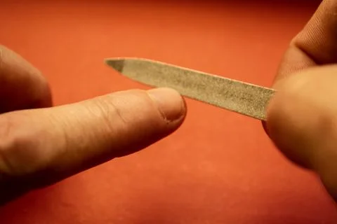 We process the nails on the hands with a nail file. Stock Photos