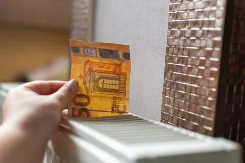 We put the bill in a white heating radiator Stock Photos