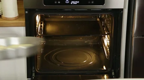 We put the container with pies in the oven Video stock 49781853