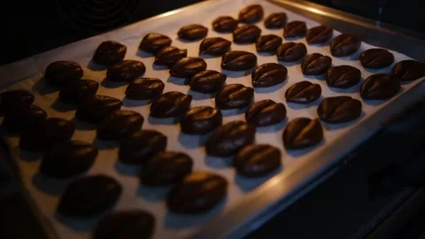 We put cookies in the form of coffee beans to bake Stock Footage 194737822