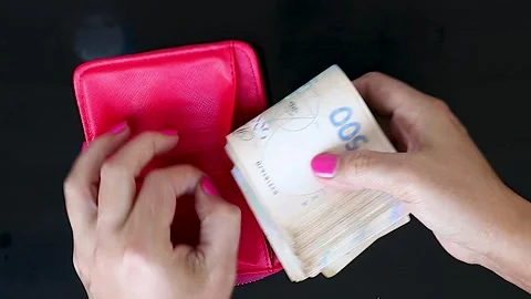 We Put Money in Our Red Wallet. The Concept of Financial Work. Money, Win, Rich Stock Footage 246544995