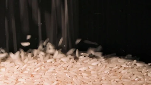 We put rice. Slow motion Falling grains. Concertual video. Stock Footage 125942955