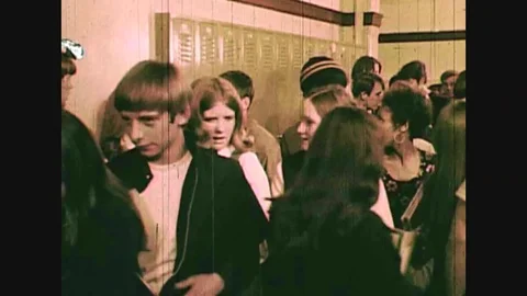 We see Sonny at high school walking down the hall and then attending class where Stock Footage 111348689
