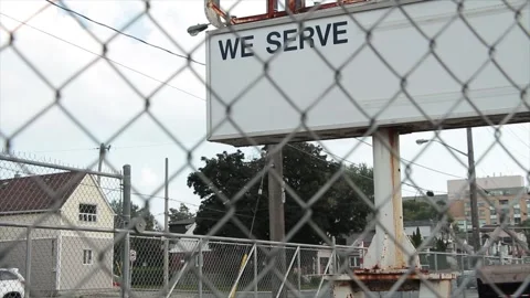 We serve caption text writing billboard horizontal rectangle sign on metal posts Stock Footage 249418137