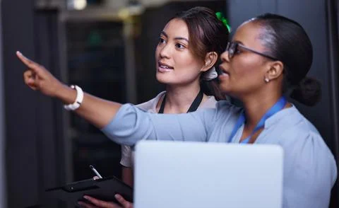 We should check that one next. two attractive young female computer programmers Stock-Fotos