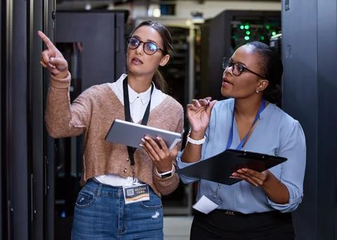 We should check those servers next. two attractive young female computer Foto stock