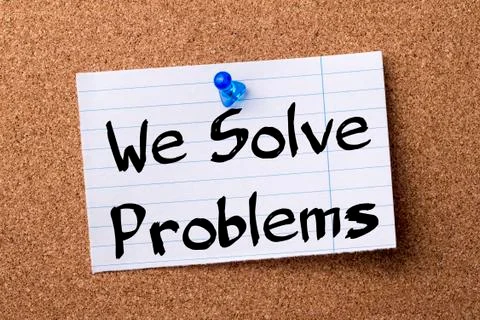We Solve Problems - teared note paper pinned on bulletin board 写真素材