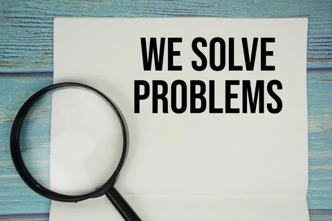 We Solve Problems text written on notepad with magnifying glass flat lay on.. Foto stock