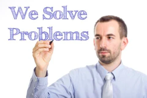 We Solve Problems - Young businessman writing blue text on transparent surfac 写真素材