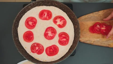 We spread ripe tomato rings on top of the pita bread Видео 252243097