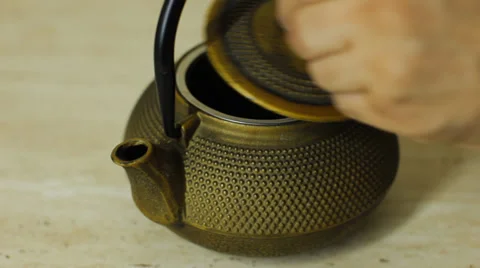 We uncover a teapot Stock Footage 30643892