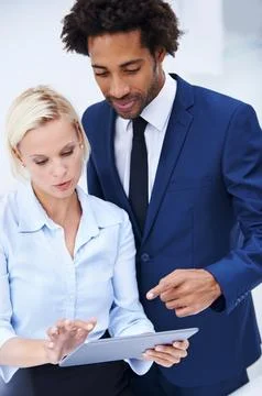 We use the latest tech for greater efficiency. two colleagues discussing Stock Photos