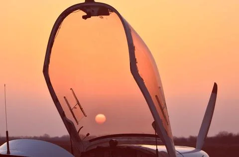 We watch the sunset through the lantern of the plane Stock Photos