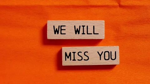 We will miss you message writing on wooden blocks on orange background Stock Footage 284439781