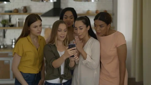 We won! 5 girlfriends are looking at the phone waiting for results. Girls Stock Footage 114184114