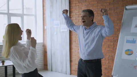 We won! business office workers rejoice at success near the whiteboard. concept Stock Footage 112830932
