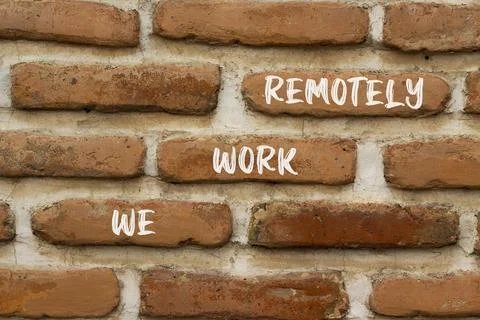 We work remotely symbol. Concept words We work remotely on beautiful brown .. Stock Photos