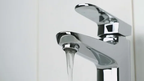 Weak flow of water pouring from chrome faucet Stock-Footage 72472227