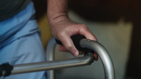Weak senior male with disability standing up using a walker, rehabilitation Stock Footage 331162682