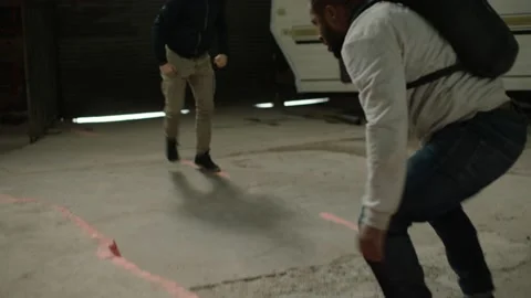 Weaker man is punched by a strong man in front of an abandoned camper trailer in Stock Footage 199452958