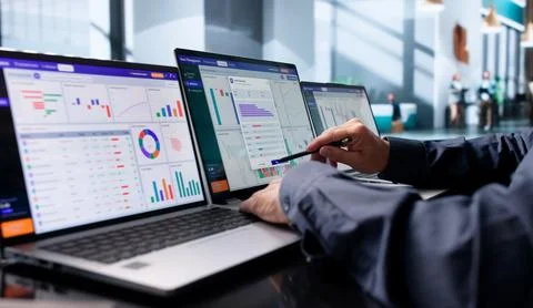 Wealth Advisor Studies Portfolio Data On Laptop, Planning Client Investments  Stock Photos