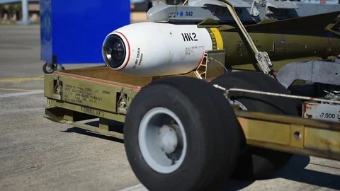 Weapon being lifted with bomb loader for loading onto F-16  Stock Footage 83309379