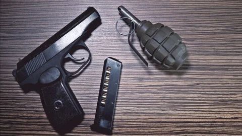 The weapon lies on the table: a cannon, a grenade, handcuffs, clips, bullets Stock Footage 74443600