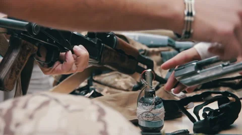 Weapons, Automatic Machines, Grenades, Ammunition, Bullets are on the Table, and Stock Footage
