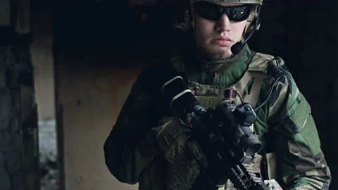 Weapons close-up on a military man standing inside the building and waiting for Stock Footage 137363055