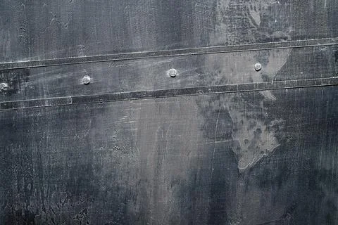 Weared down old metal sheet conected with rivets in the center. Stock Photos