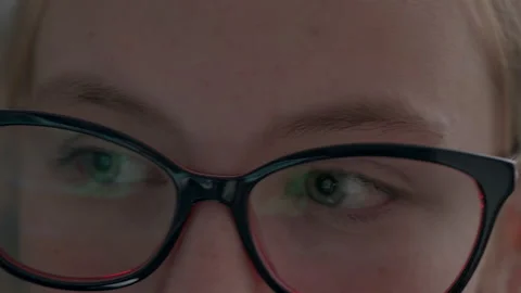 Wearing computer glasses to reduce eye strain when using a computer. Close-up Stock Footage 167434552