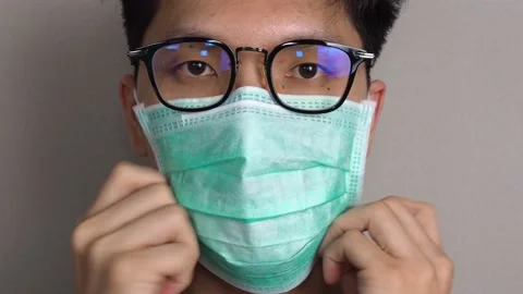 Wearing a face mask in action close up Stock Footage 130423892