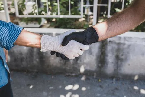 Wearing gloves to avoid monkeypox and diseases. gloved hands hold. Stock Photos