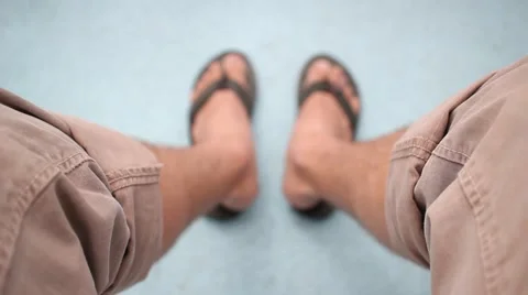 Wearing rolled up pants and looking down at sandals Stock Footage 2185565