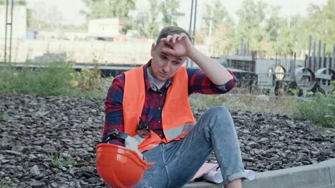 Weary young builder suffering from overwork on building site Stock Footage 274406474