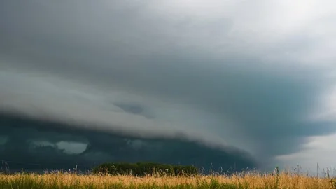 WEATHER 4K - Dramatic Dark Rain Storm Cloud Coming over Fields and Country Road. Stock Footage 279471494