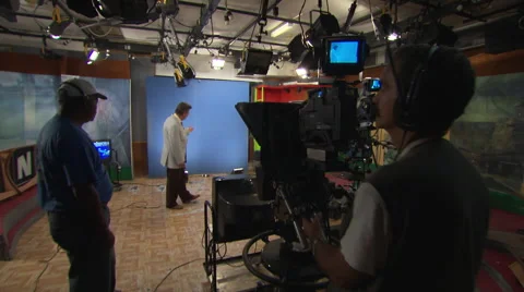 Weather forecaster in front of studio camera and blue screen Stock Footage 39993178