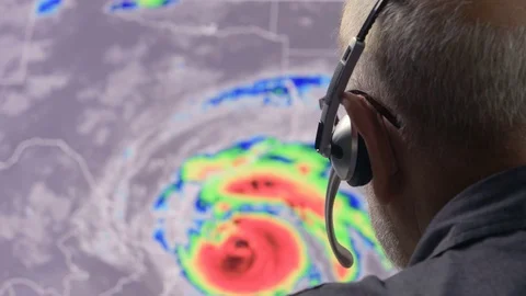 Weather man tracking a tropical storm on  computer screen Stock Footage