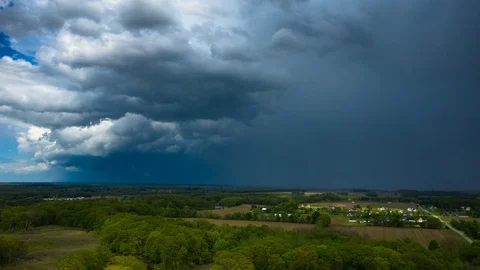 Weather - Storm Clouds Passing Above Rural Area 2 - 4K Aerial Hyperlapse Stock Footage 110753383