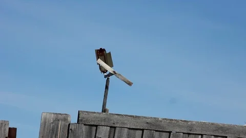 Weather vane flugel blows the wind in the village Stock Footage 87240017