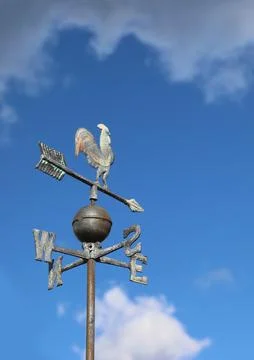 Weather vane in the shape of a rooster to indicate the direction of the wind  Фото