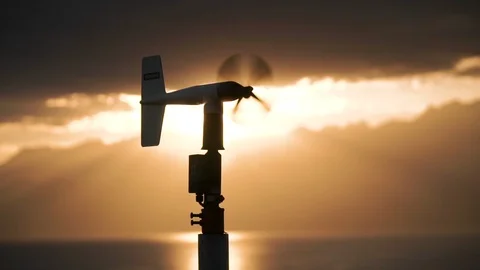 Weather vane silhouetted by the sunlight. Sunset on the lake Stock Footage 122621165