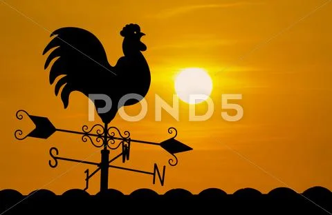 Weather vane in sunrise Stock Photos