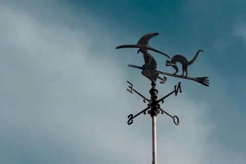 Weather vane of a witch. Stock Photos