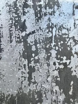 Weathered and distressed metallic surface with peeling black paint Stock-Fotos